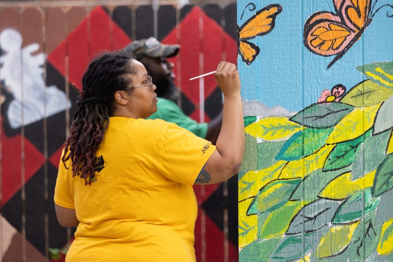 Community members paint a shed at the Third Ward Chess Park in Houston, Texas, USA. Rotary clubs from the Houston area and their community partners turned a vacant lot into a park with picnic and chess tables, garden beds, and public art. 14 November 2021.
